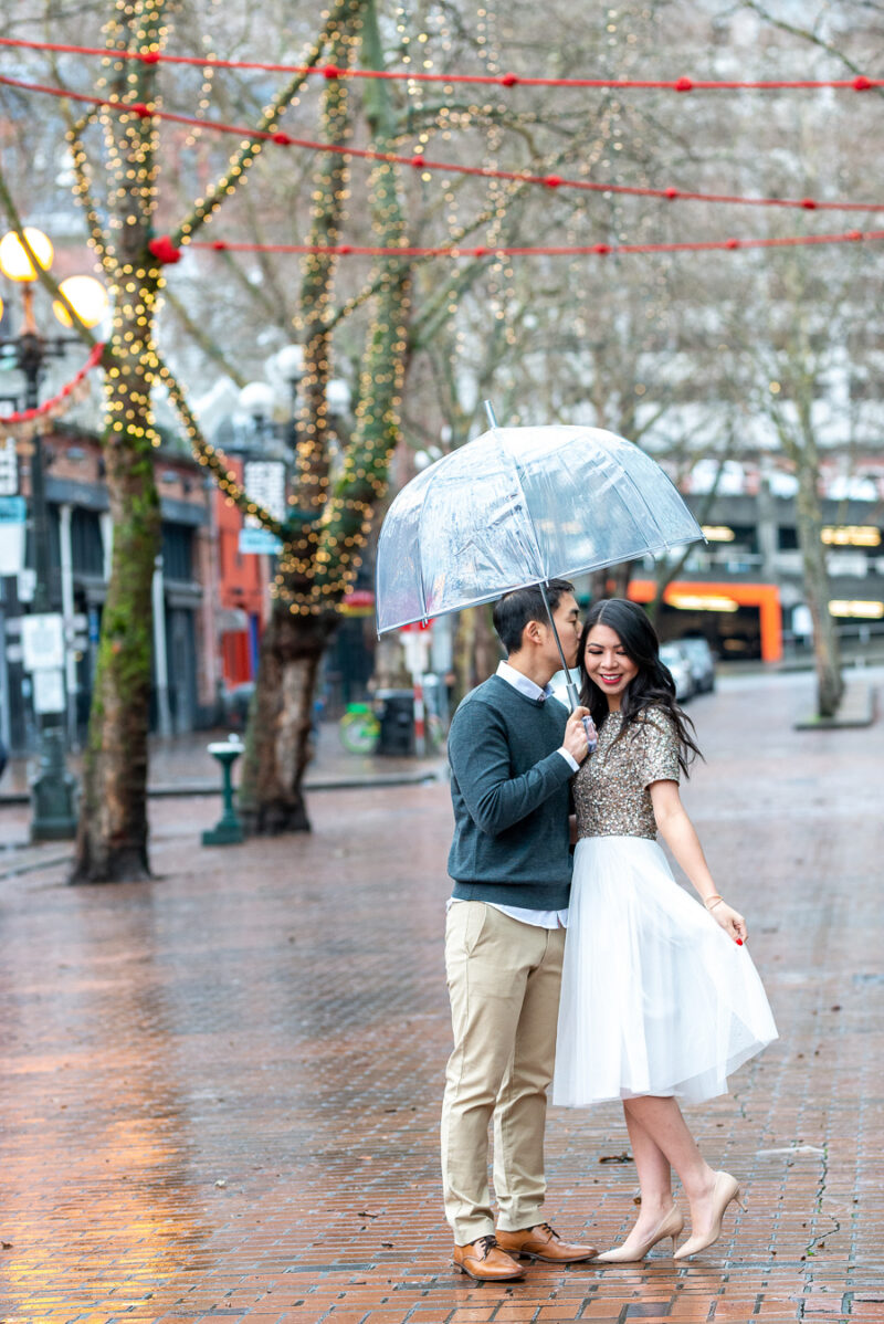 Seattle engagement photos in Pioneer Square, Occidental Park, holiday shoot, rainy engagement photos with clear umbrella, Seattle fashion blogger Just A Tina Bit