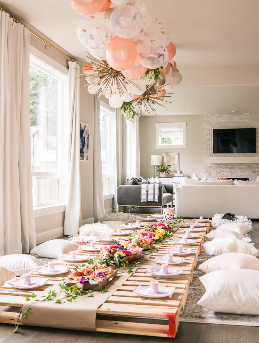 Picnic bridal shower with wood pallets, balloon garland, exotic fruit platters, table setting with mini rose boxes as party favors
