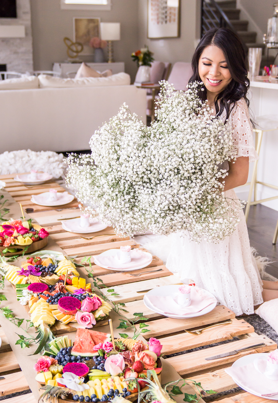 Picnic bridal shower with wood pallets, baby's breath flowers, white eyelet dress for bridal shower