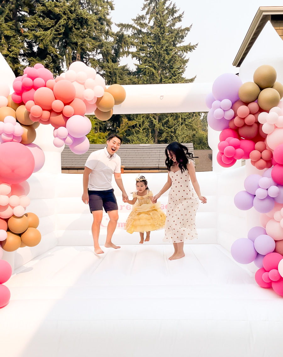 White bounce house family photo, birthday girl