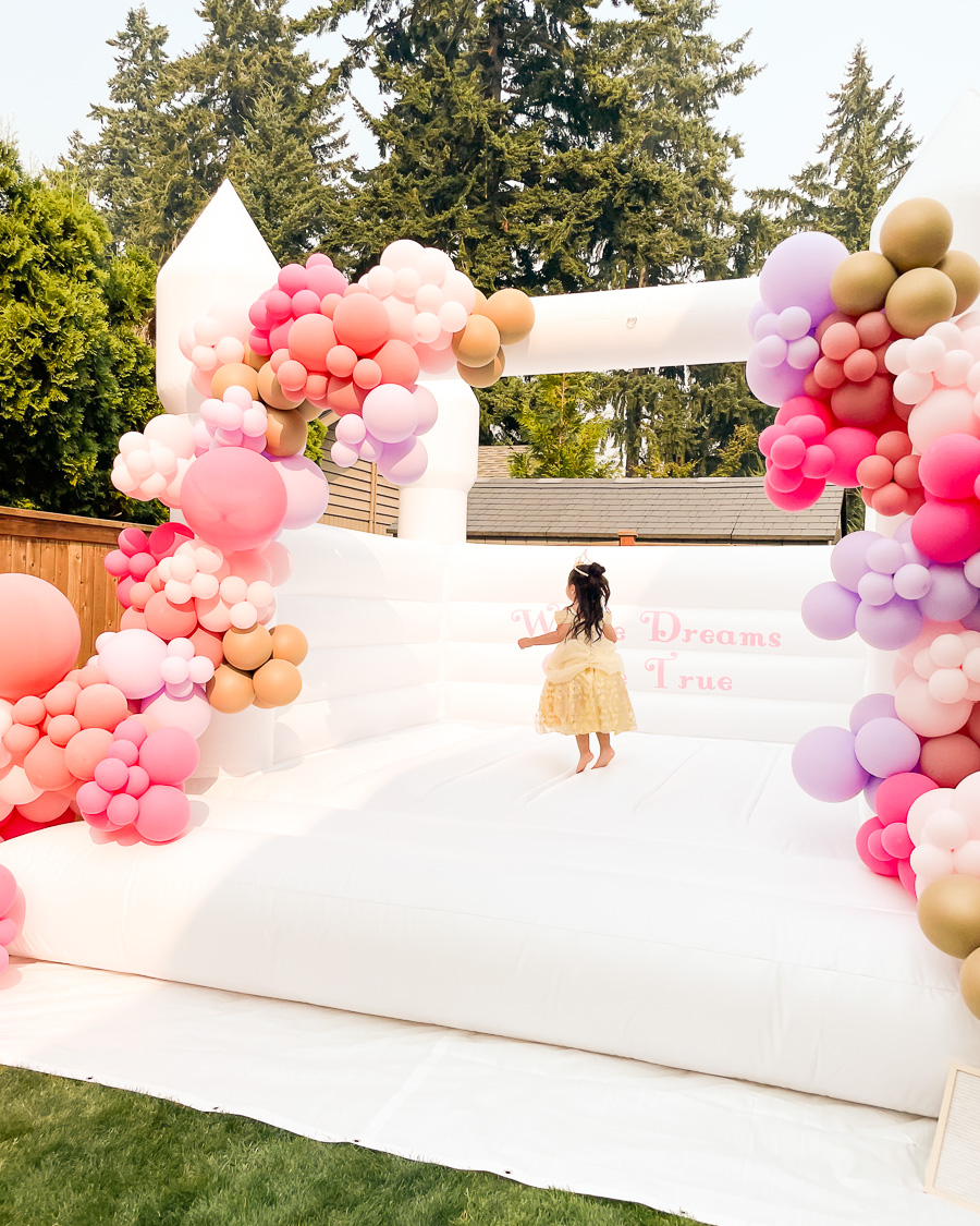 Disney princess birthday party, pink and purple balloon garland, white castle bounce house, where dreams come true vinyl decal